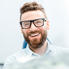 Smiling man sitting in dental office