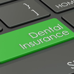 Green dental insurance key on computer keyboard