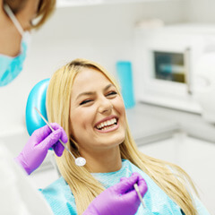 Laughing woman in dentist’s chair