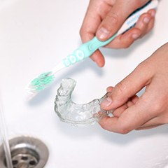 Invisalign aligners being brushed