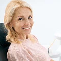 Older woman smiling in dental chair.