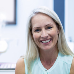 Older woman in dental office smiling