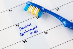 a calendar with a dental appointment reminder written on it