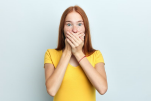 Woman covering her mouth with her hands