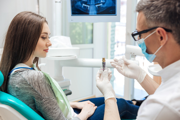 patient learning about dental implants